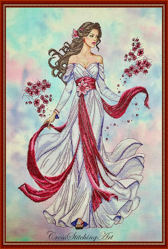 Finished Amariel Enchanted Blossom cross stitch in white gown with magenta ribbons and pink blossoms
