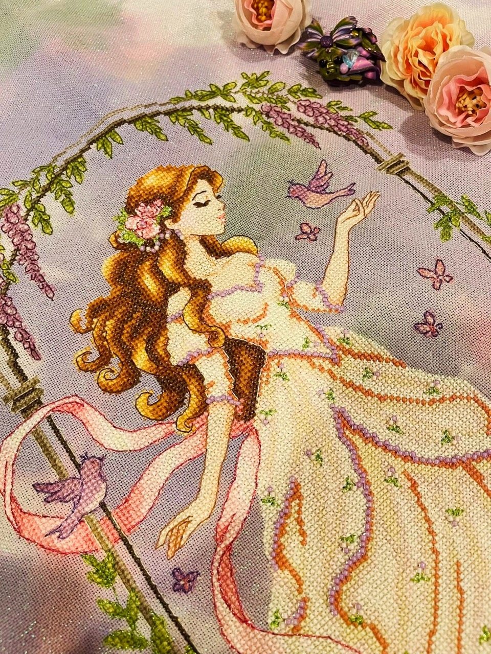 Close-up of stitched ribbon, flowers and beadwork